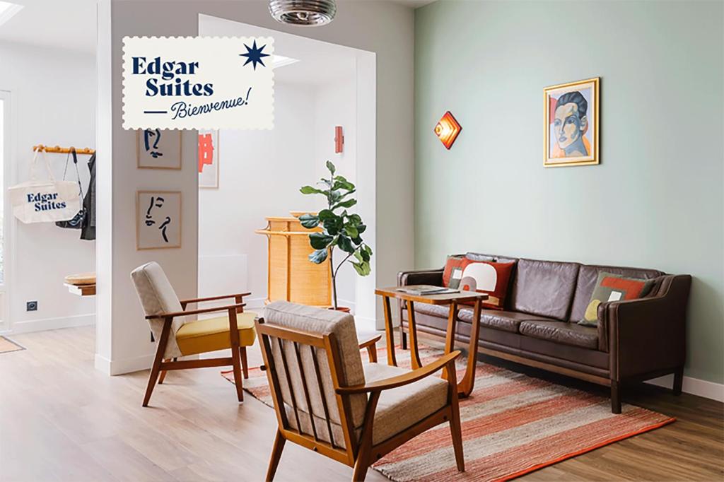 a living room with chairs and a couch at Edgar Suites Notre-Dame - Lagrange in Paris