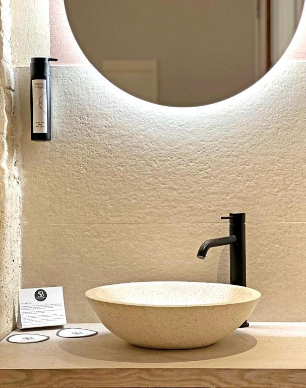 a bathroom with a bowl sink and a mirror at Soho Boutique Cádiz in Cádiz