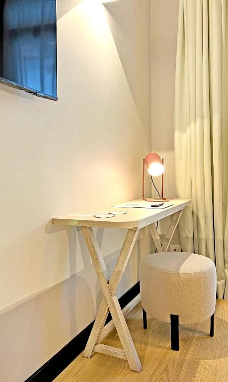 a white desk with a chair and a lamp at Soho Boutique Cádiz in Cádiz