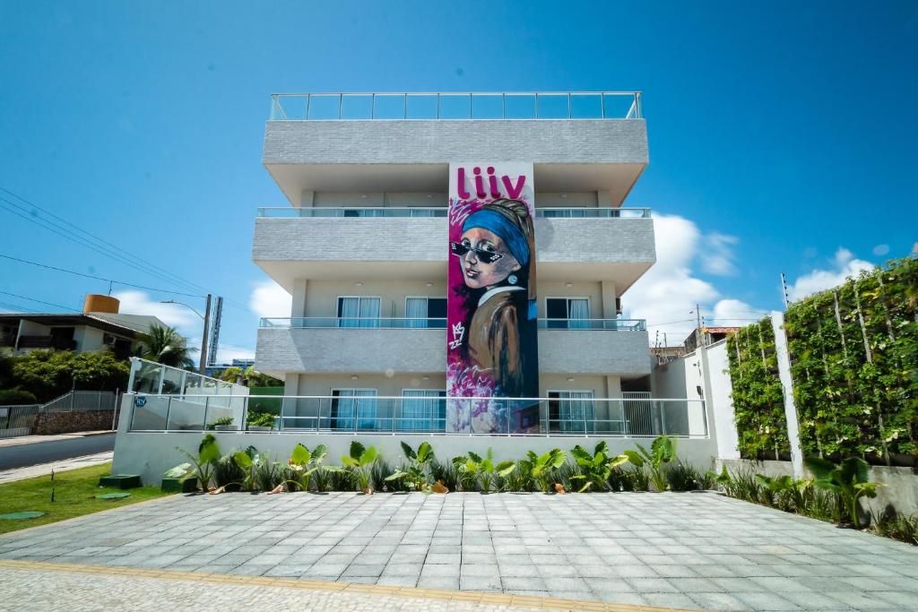 a building with a painting of a woman on it at Liiv Mar - Natal Ponta Negra in Natal
