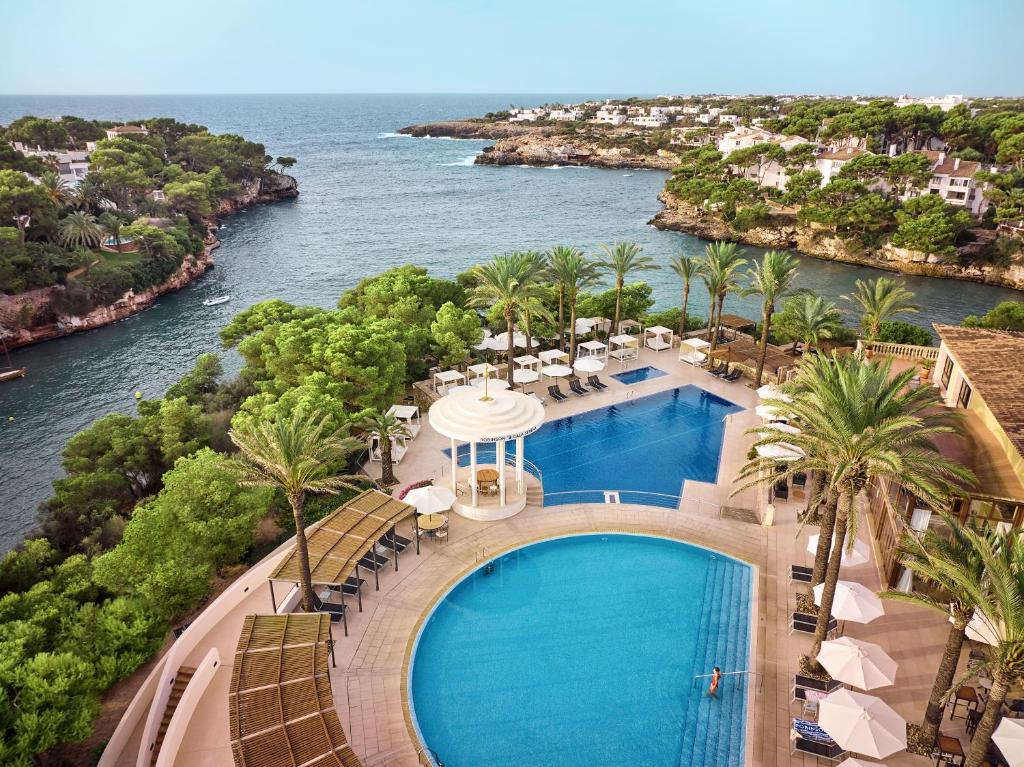an aerial view of a resort with a swimming pool at ROBINSON Cala Serena in Cala Serena