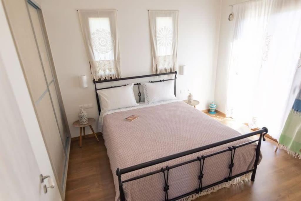 Łóżko lub łóżka w pokoju w obiekcie Villa Asprolia