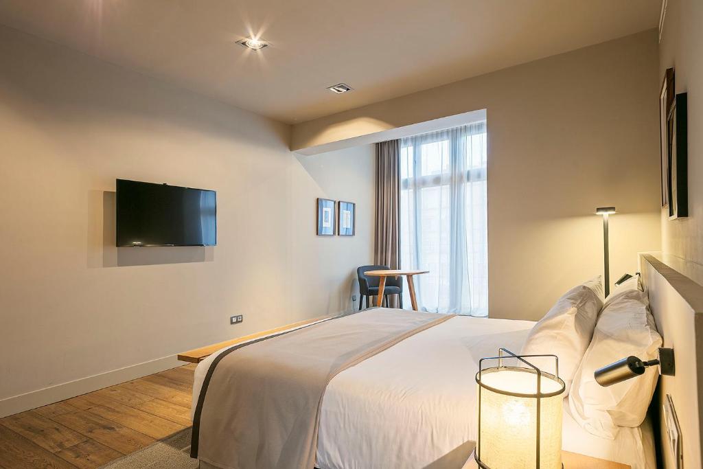 Postel nebo postele na pokoji v ubytování Uma Suites Pau Claris