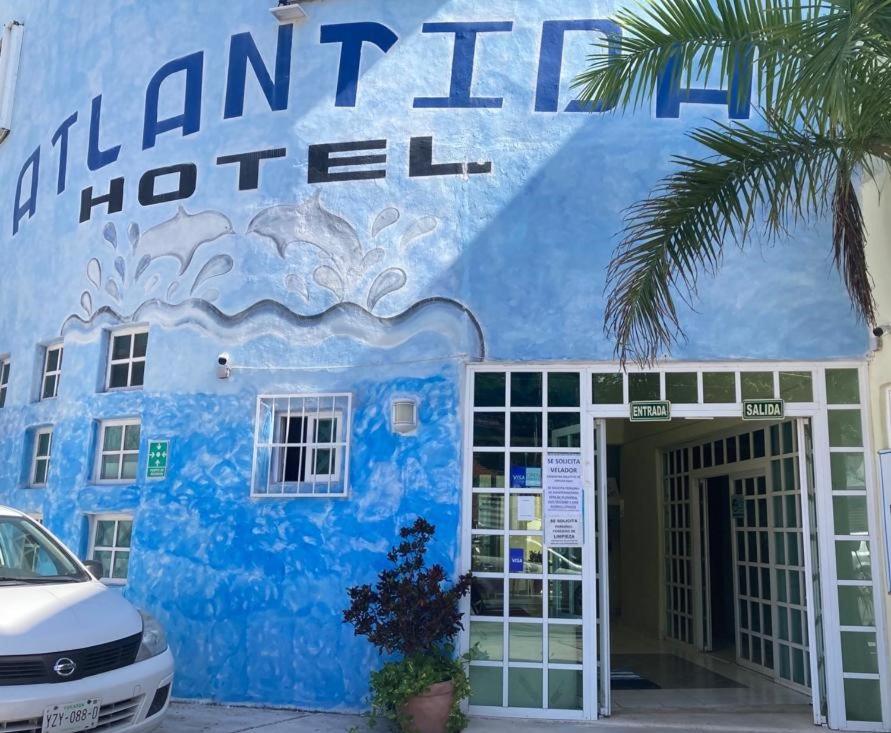 a blue building with the name of a hotel at HOTEL ATLANTIDA in Playa del Carmen