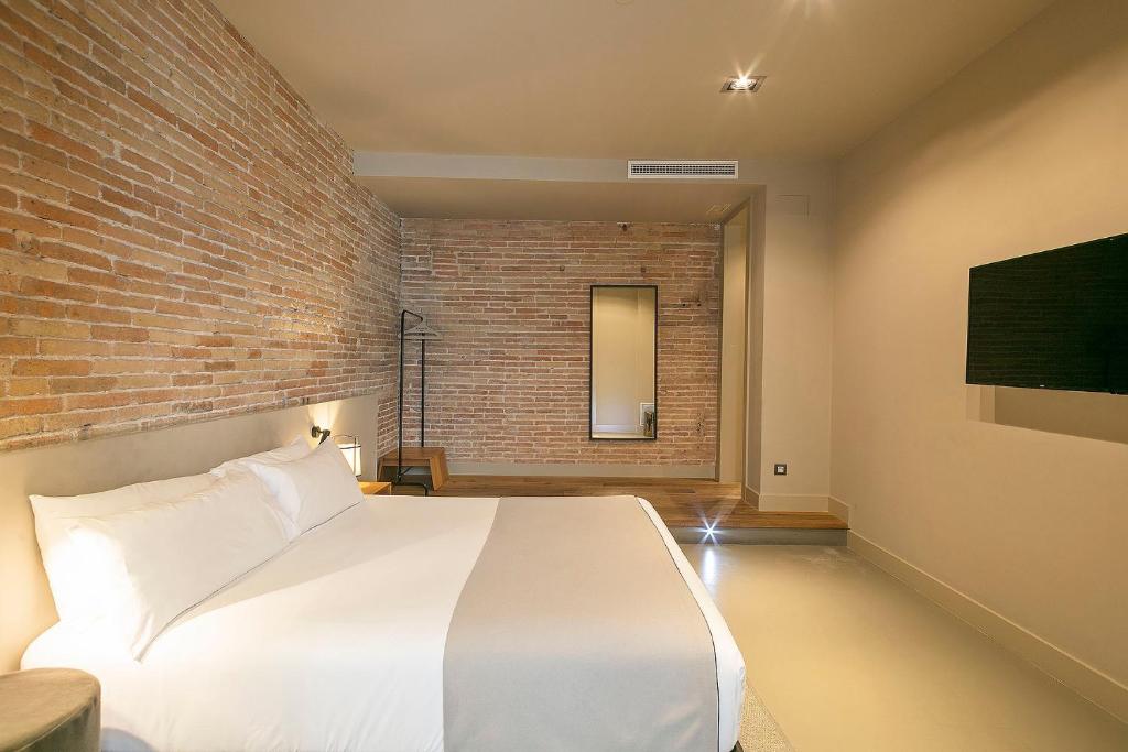 Postel nebo postele na pokoji v ubytování Uma Suites Pau Claris