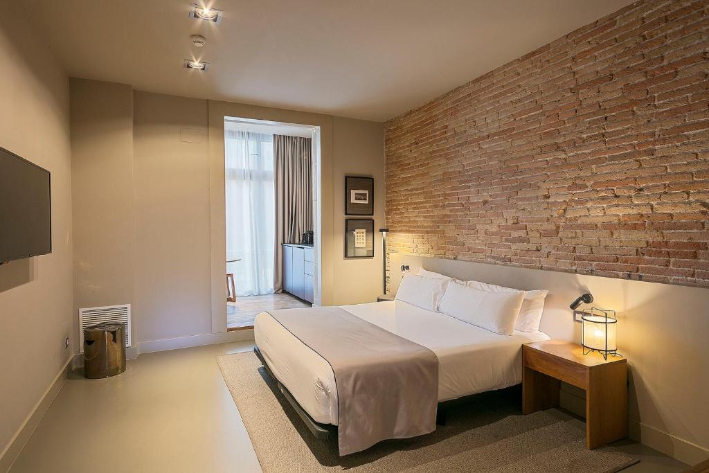 Postel nebo postele na pokoji v ubytování Uma Suites Pau Claris