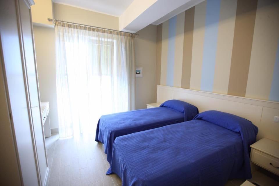Postel nebo postele na pokoji v ubytování Hotel Al Rustico
