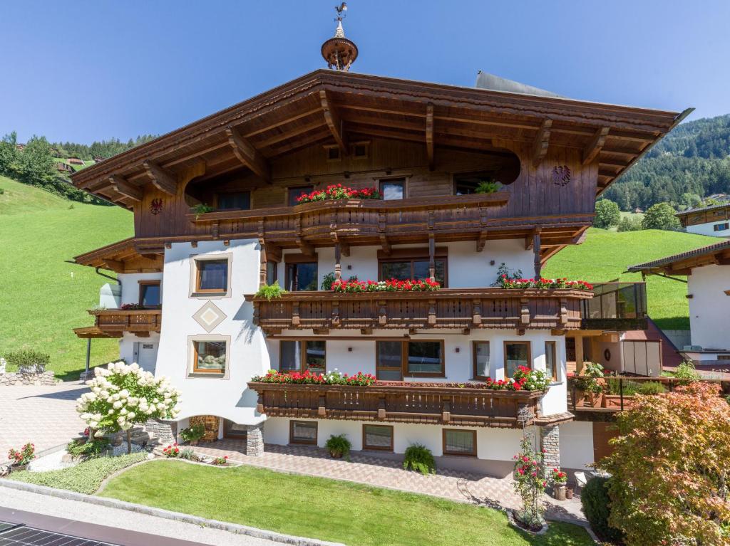 a building with flowers on the balconies of it at Haus Bergheim in Ramsau im Zillertal