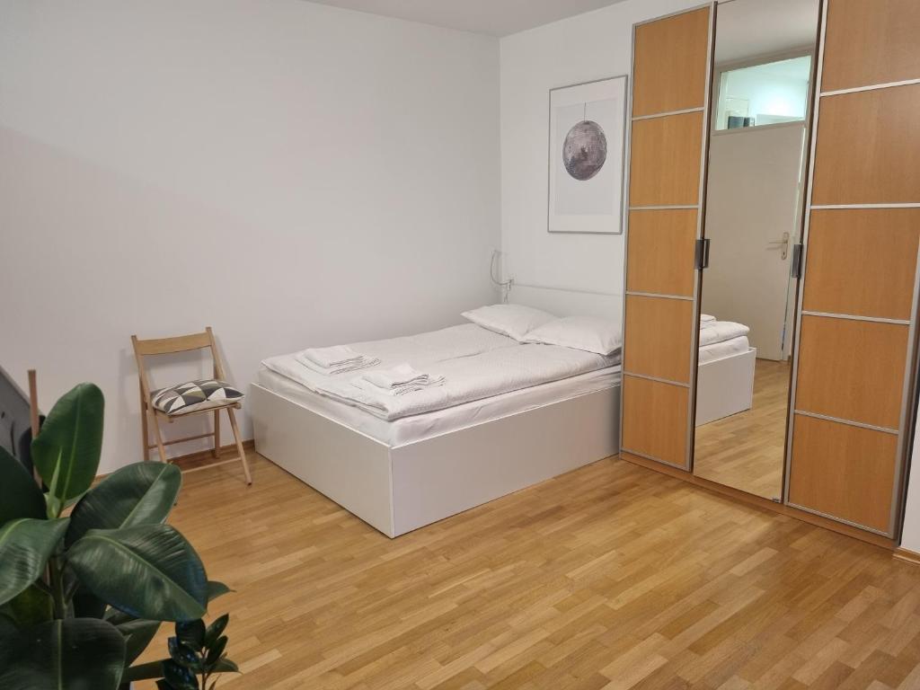 a small bedroom with a bed and a mirror at Little cozy apt close to centre in Ljubljana