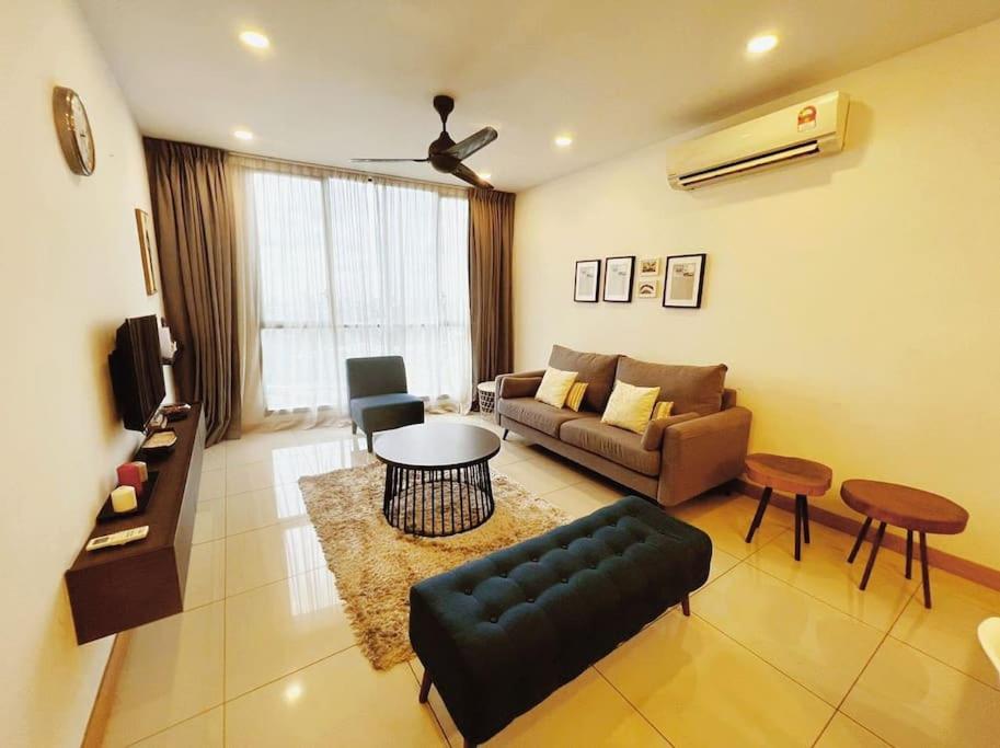 a living room with a couch and a table at [PROMO]Connected train 2 Bedroom (ABOVE MALL)15 in Kuala Lumpur