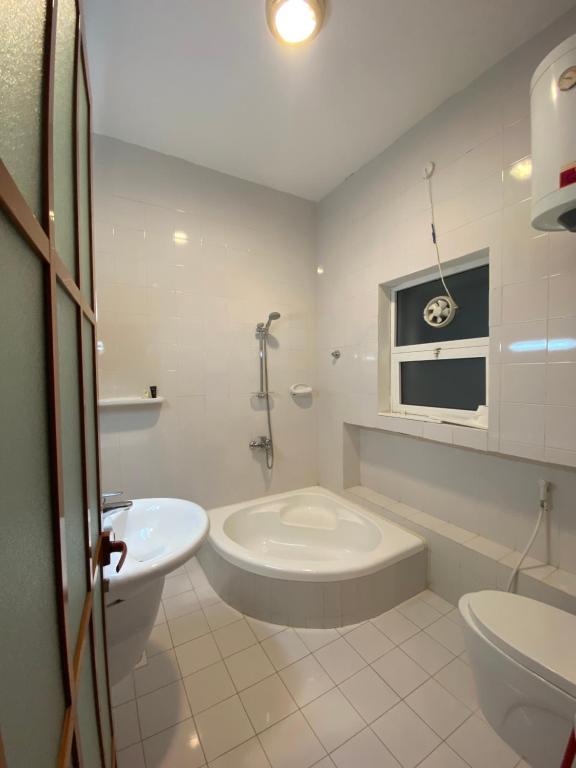 a white bathroom with a sink and a toilet at Aryaf hostel in Nizwa