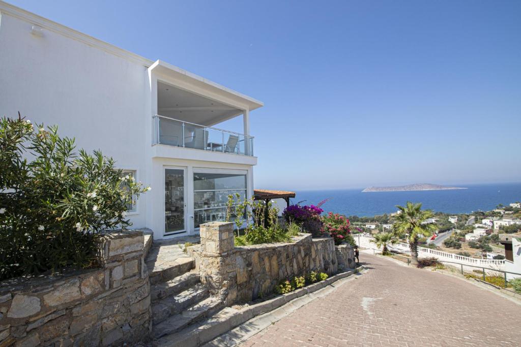 a white house with a view of the ocean at Amazing Duplex House with Sea View in Bodrum in Gumusluk