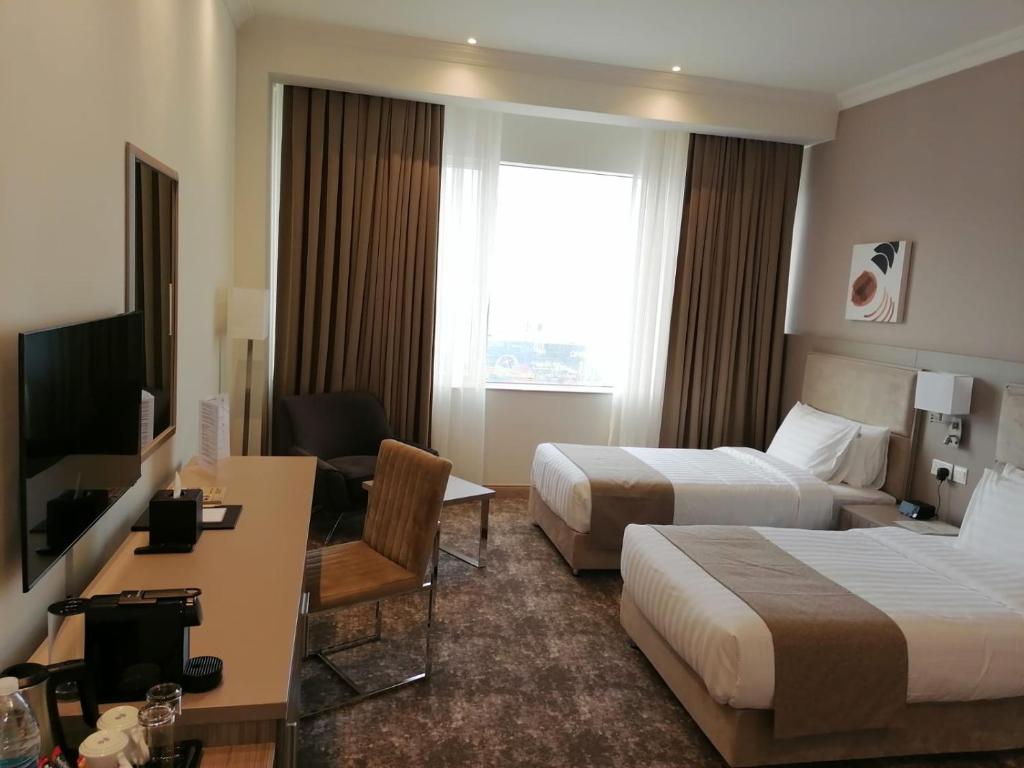 TV a/nebo společenská místnost v ubytování Gloria Hotel & Suites Doha