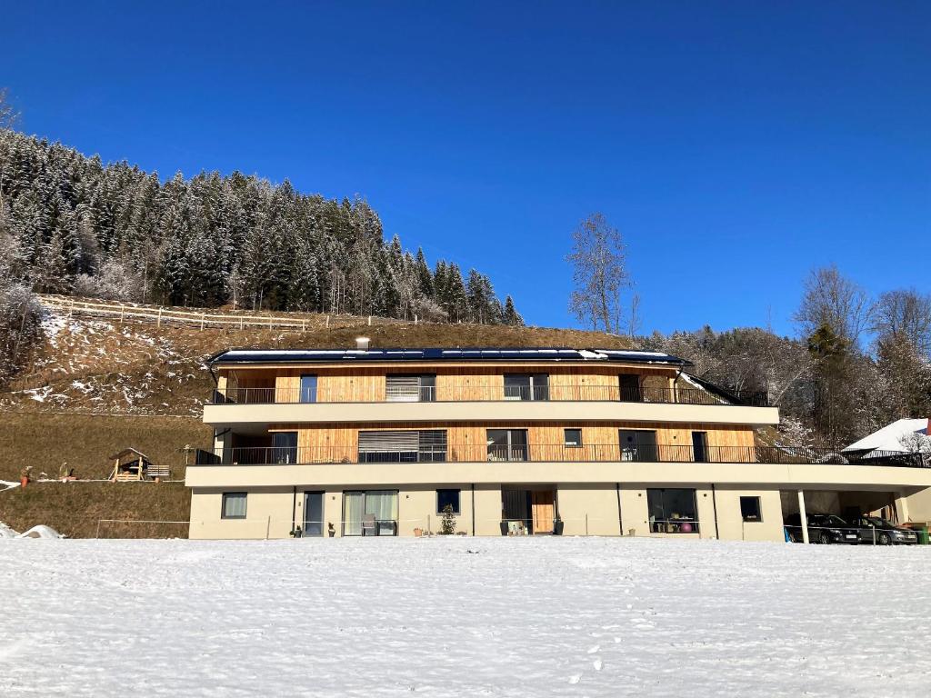 a large building with snow in front of it at Appartement Heimatliebe in Schladming