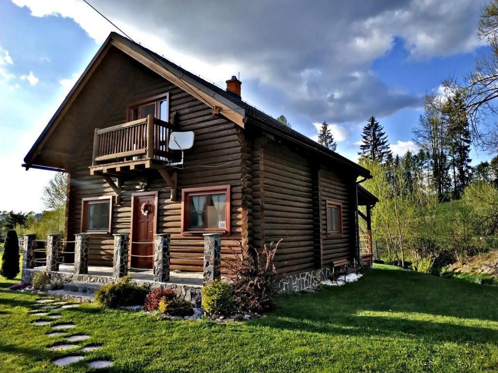 a log cabin with a porch and a balcony at Rozprávkový zrub in Dúbrava
