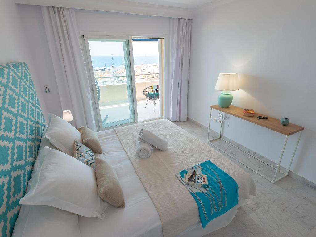 a bedroom with a bed with a view of the ocean at VACATION MARBELLA I Puerto Banus Sea Front, Terrace, Puerto Banus Marina, Pool in Marbella