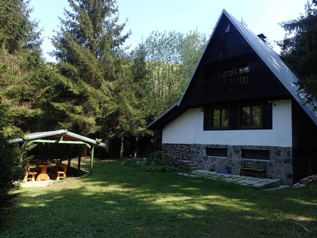 una casa con techo negro y patio en Chata Krpáčovo en Horná Lehota