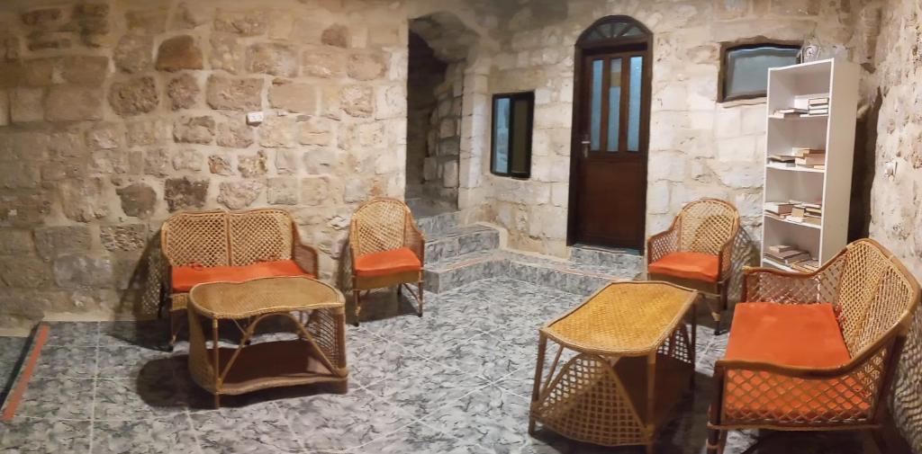 a group of chairs in a room with a door at Jaffa Gate Hostel in Jerusalem