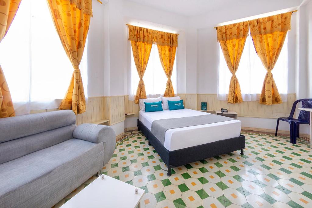 Hotel Ayenda Macondo tesisinde bir odada yatak veya yataklar