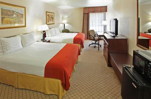 a hotel room with two beds and a television at Holiday Inn Express - Hope by IHG in Hope