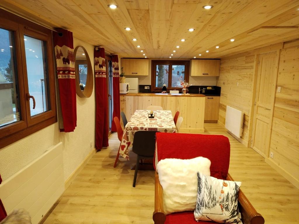 a dining room and kitchen with a table and chairs at le face au tremplin Appartement 5 pers entièrement rénové dec 2022 classé meublé de tourisme 3 étoiles emplacement unique a Autrans proche du village prestations de qualité in Autrans