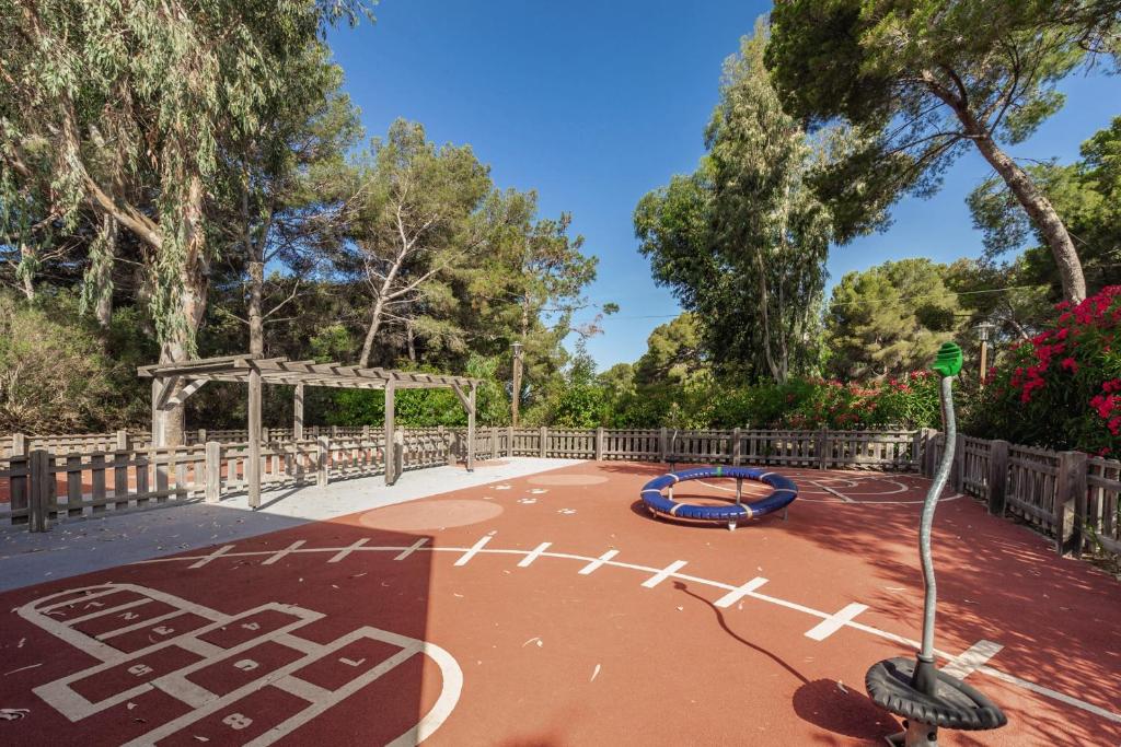 a basketball court in a park with a playground at Belambra Clubs Presqu&#39;île De Giens - les Criques in Hyères