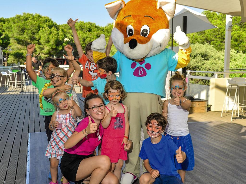 a group of children posing in front of a mascot at Belambra Clubs Presqu&#39;île De Giens - les Criques in Hyères