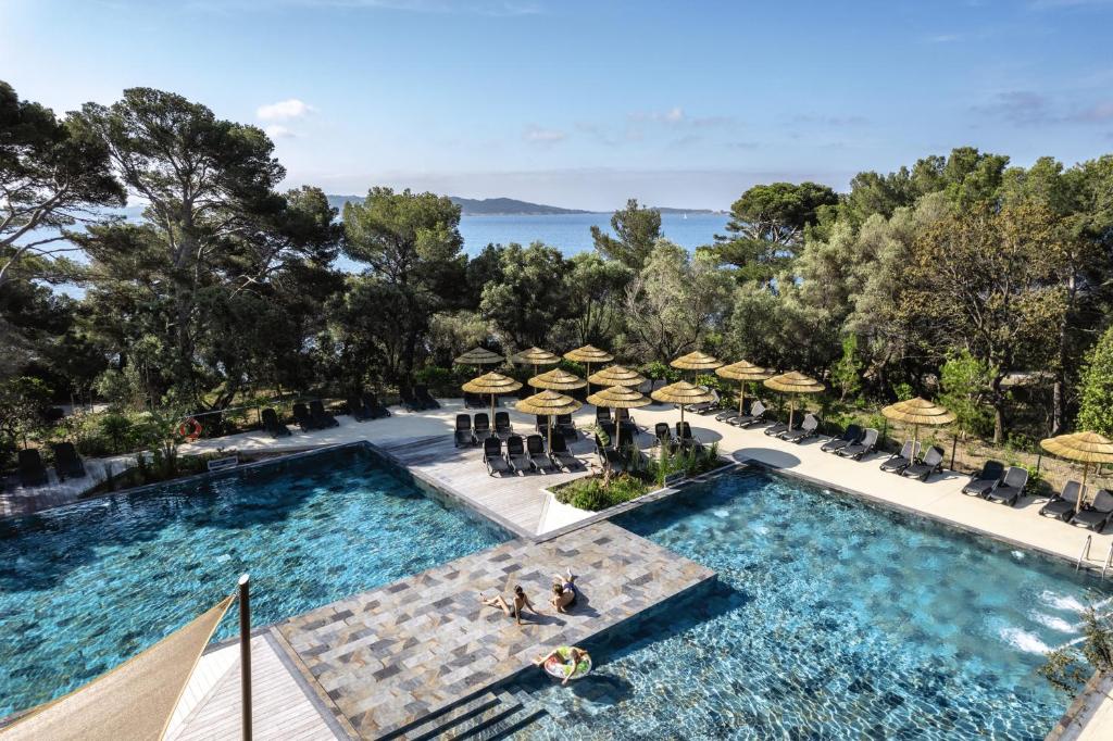 an overhead view of a swimming pool with chairs and umbrellas at Belambra Clubs Presqu&#39;île De Giens - les Criques in Hyères