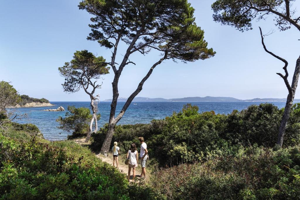 a family walking on a trail near the ocean at Belambra Clubs Presqu&#39;île De Giens - les Criques in Hyères