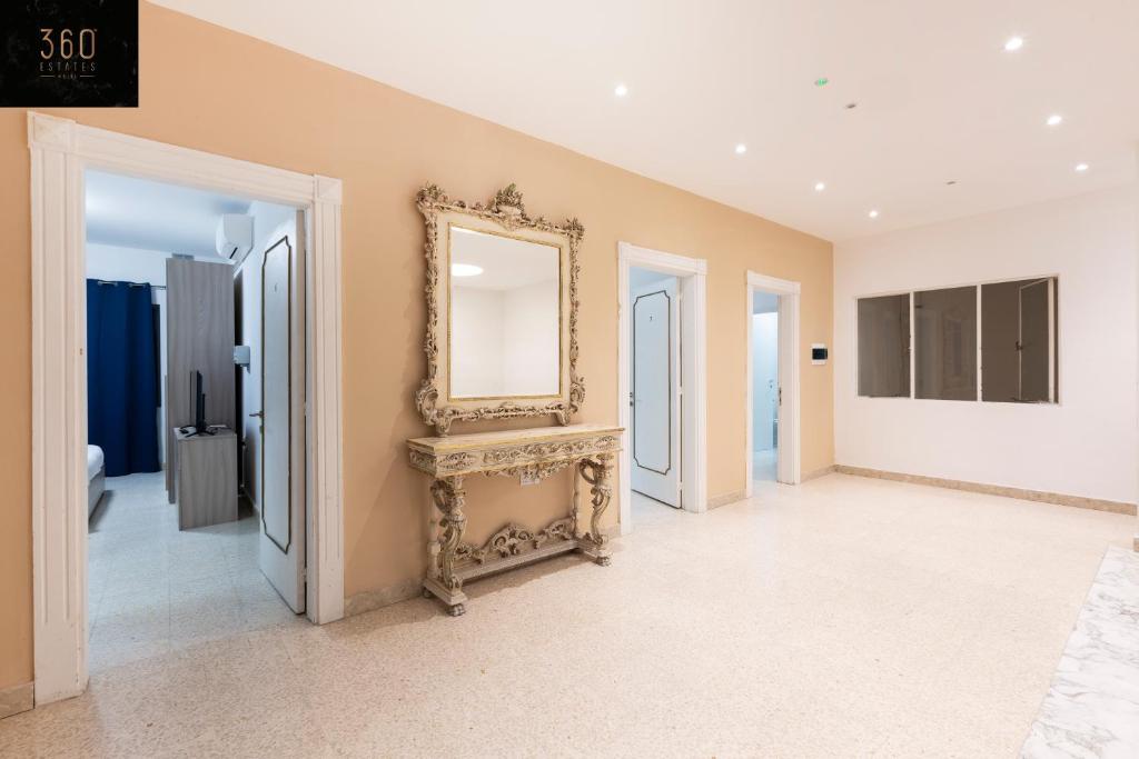 a room with a mirror on the wall and some doors at Spacious NUM1 house in Swieqi - Sleeps 18 w&#47;WIFI by 360 Estates in Is-Swieqi