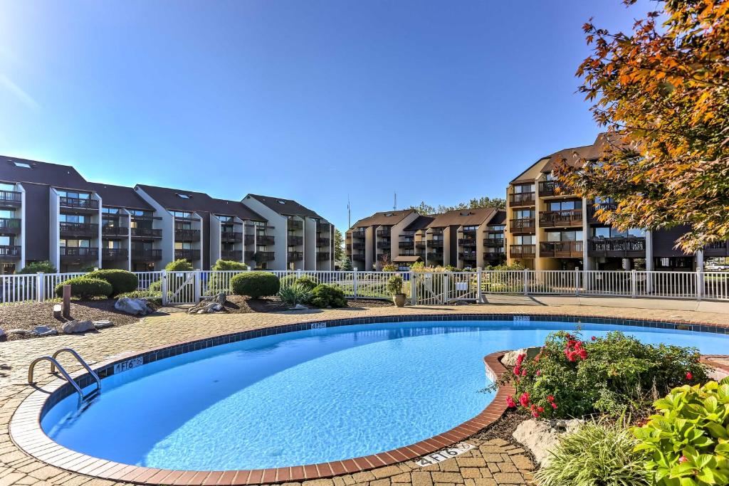 a large swimming pool in front of some apartment buildings at Waterfront Port Clinton Condo with Pool Access! in Port Clinton
