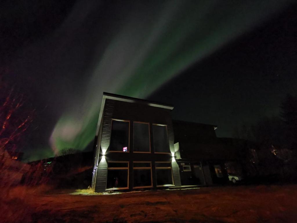 a building with the aurora in the sky at The House of Aurora II in Tromsø
