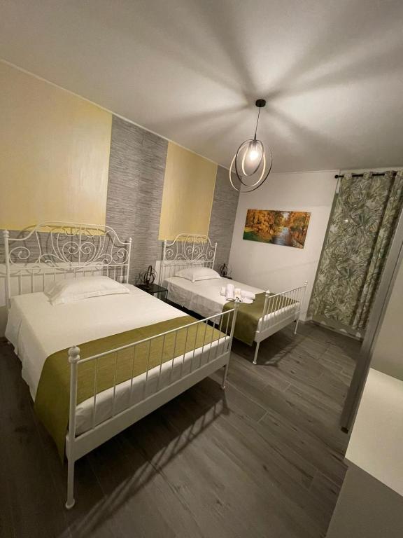 a bedroom with two beds and a tub in it at Foresteria Opera B&b in Rovato