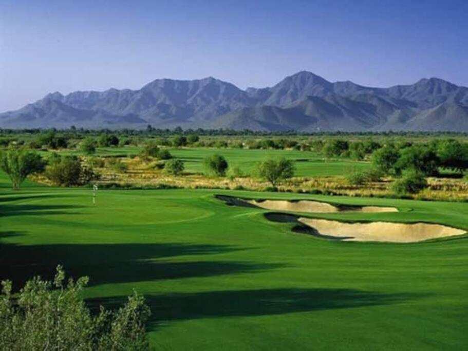 a view of a golf course with mountains in the background at Entire 2 level townhouse in Old Town Scottsdale! in Scottsdale