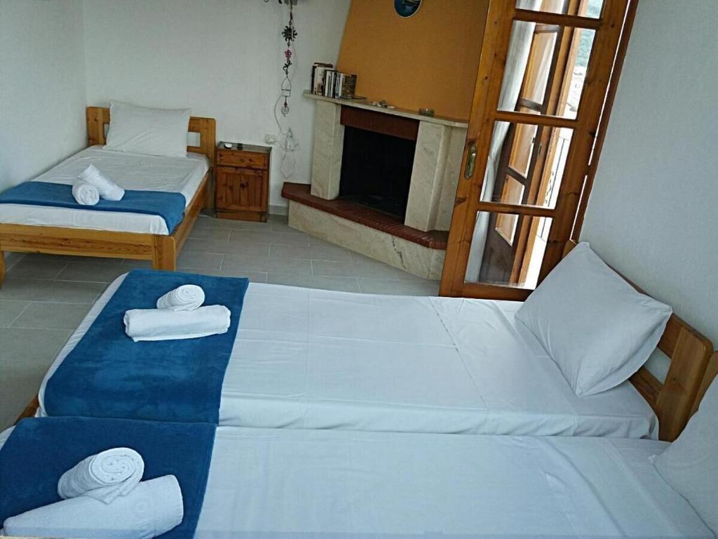 a bedroom with two beds with towels on them at nostalgo in Skiathos Town
