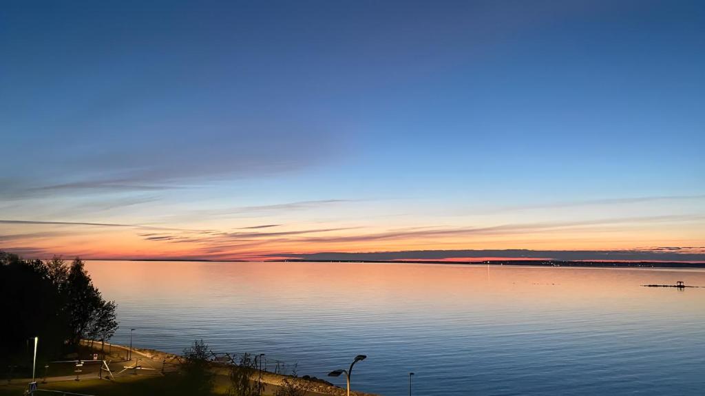 a sunset over a large body of water at Not Open - Do Not Book in Tallinn