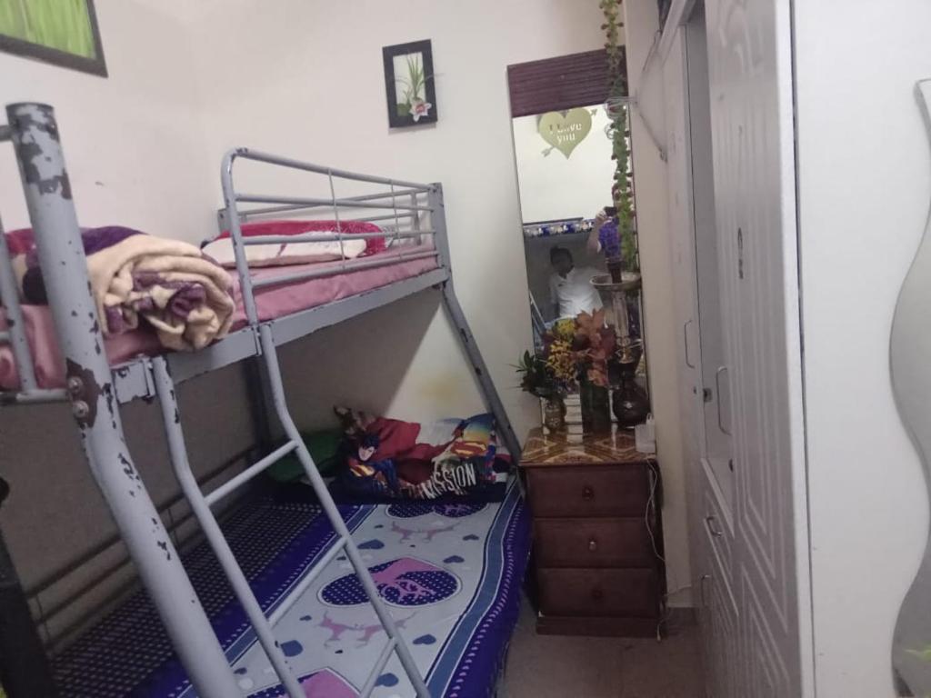 a bunk bed in a room with a hallway at dormitory bed space for male and female in Sharjah