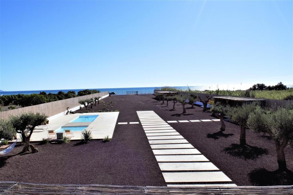 a parking lot with trees and the ocean in the background at Moott Homes Suites Villa Costacabana in Almería