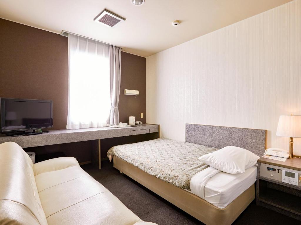 a hotel room with a bed and a tv at Hotel Tsushima - Vacation STAY 64041v in Tsushima