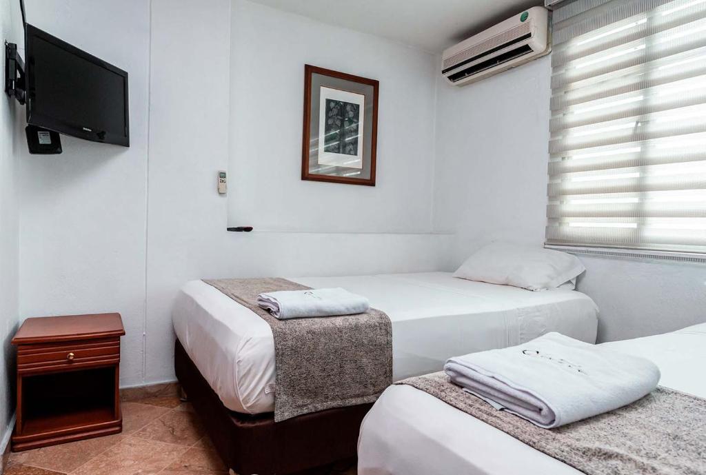 Postel nebo postele na pokoji v ubytování Hotel Cabo de la Vela Medellin