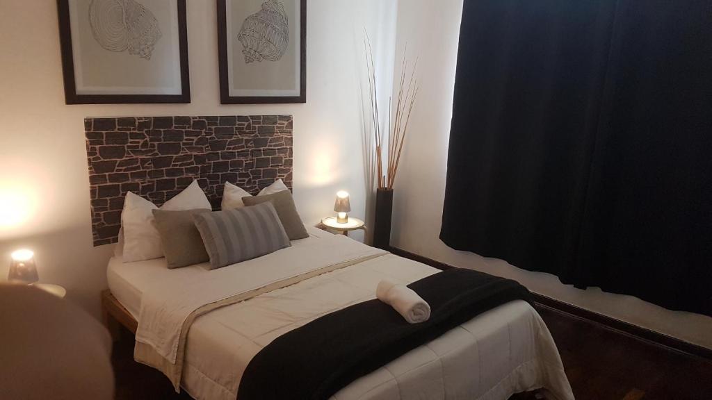 a bedroom with a bed with a teddy bear on it at Pacific Spot San Miguel in Lima