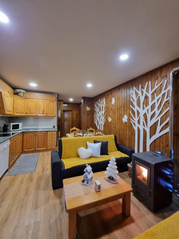 a living room with a couch and a stove at Serra da Estrela Guest House in Covilhã