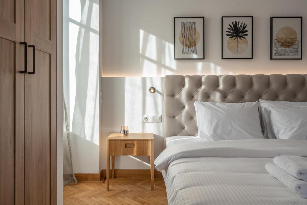 a bedroom with a bed and a table with a night stand at Upscale Athens Luxury Penthouse in Athens