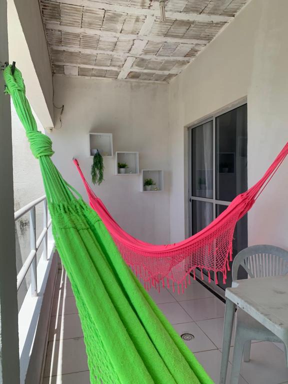 a hammock on the balcony of a house at Casa alto da Boa Vista in Maragogi