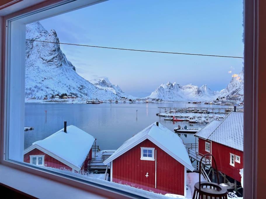 Blick auf einen verschneiten Berg aus dem Fenster in der Unterkunft Reine Front View - Mountain & Seaview in Reine