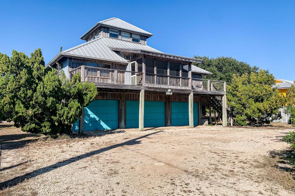 a large house with a balcony on a beach at Knot Too Shabby in St. George Island