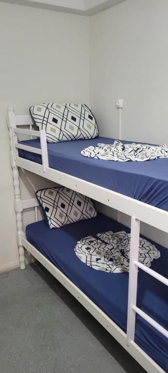 two bunk beds with blue and white pillows on them at Hostel Princess Copacabana in Rio de Janeiro