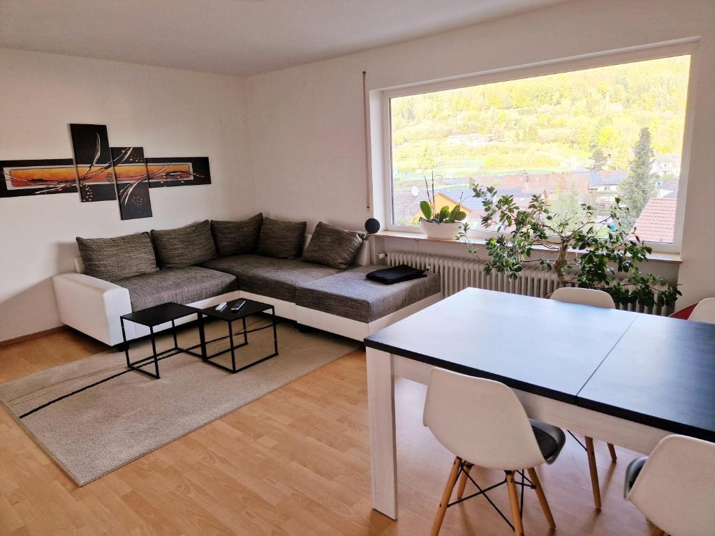 a living room with a couch and a table at Seestudio mit toller Aussicht am Bodensee in Bodman-Ludwigshafen