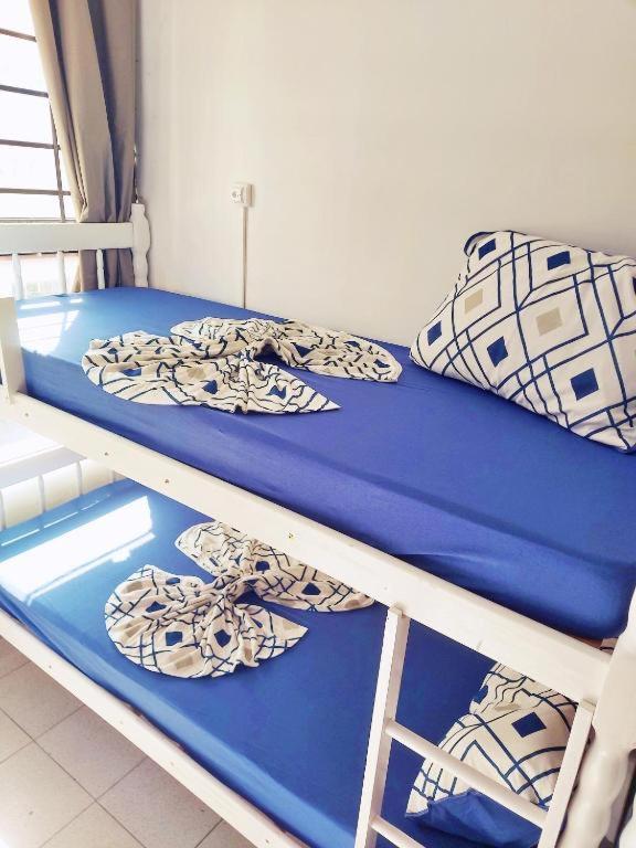 two bunk beds in a room with blue sheets and pillows at Hostel Princess Copacabana in Rio de Janeiro