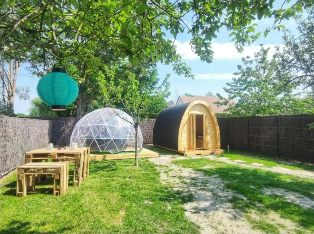 a backyard with a igloo and a dome tent at Les Pod Atypique de Sologne - Spa Privatif - Zoo de Beauval in Lanthenay